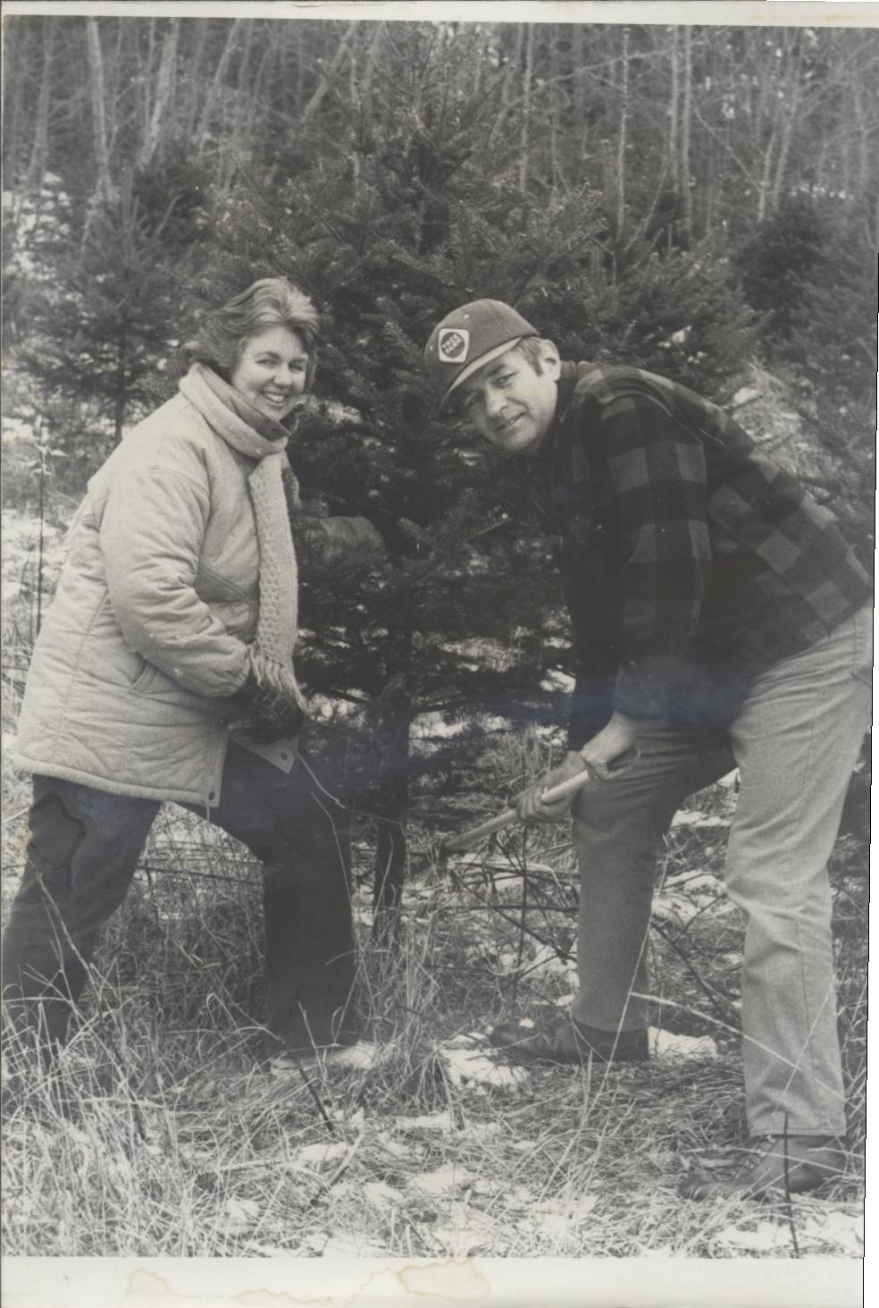 robert and prill cutting a Christmas tree